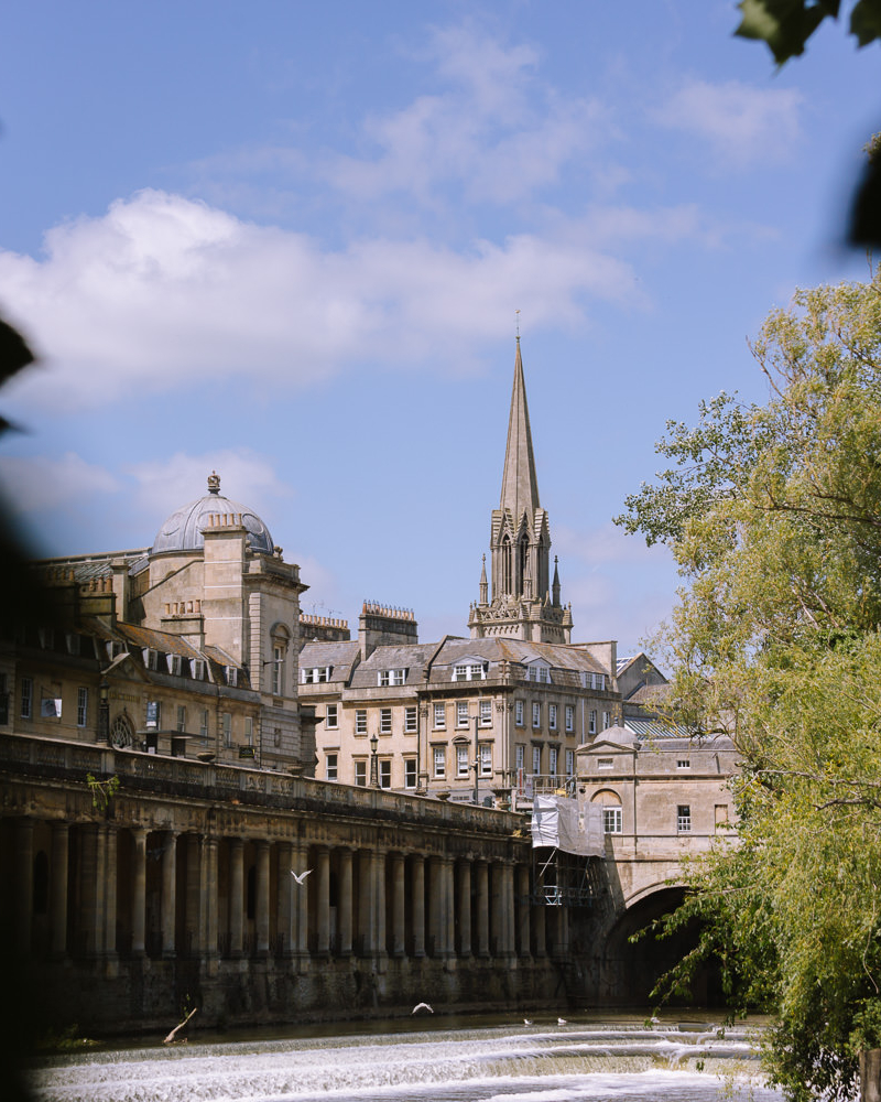 Skyline of Bath, UK across the river through the trees