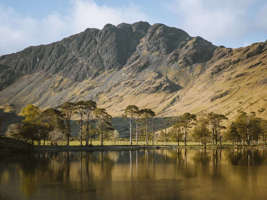 The craggy face of Haystacks behind the calm waters of Buttermere.