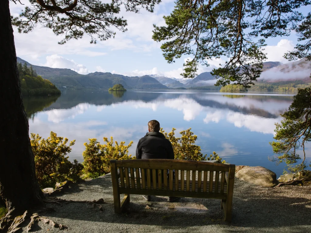 Paul sitting on a bench at the end of Friars Crag.