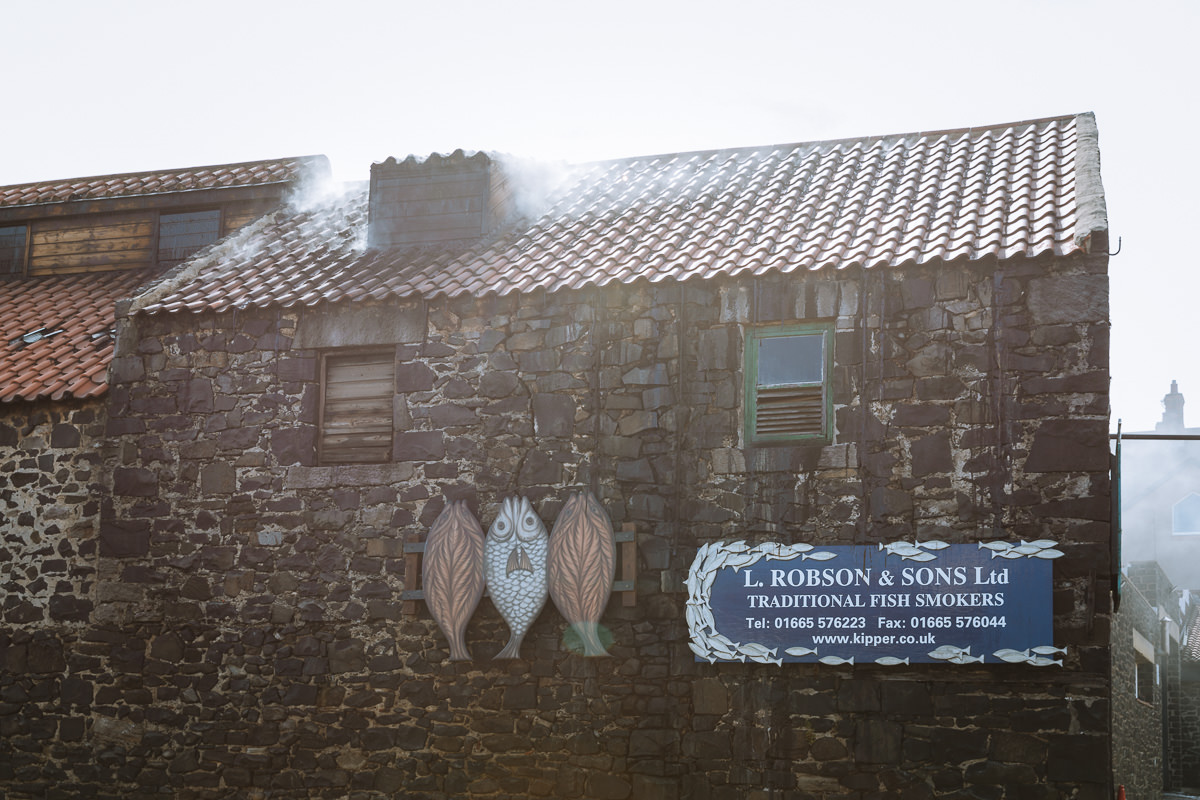 rustic stone building with ROBSON & SONS Ltd on a blue sign