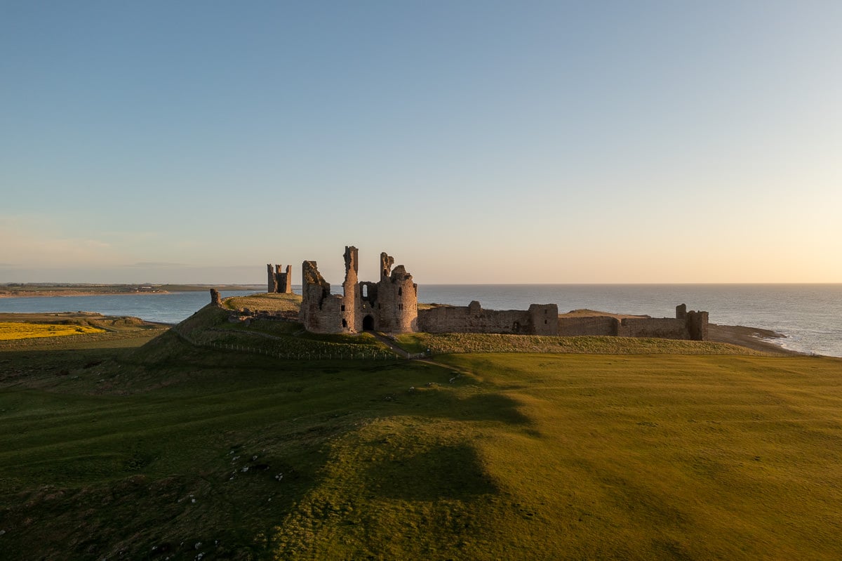 Overhead view of the remains of a large English castle beside the sea