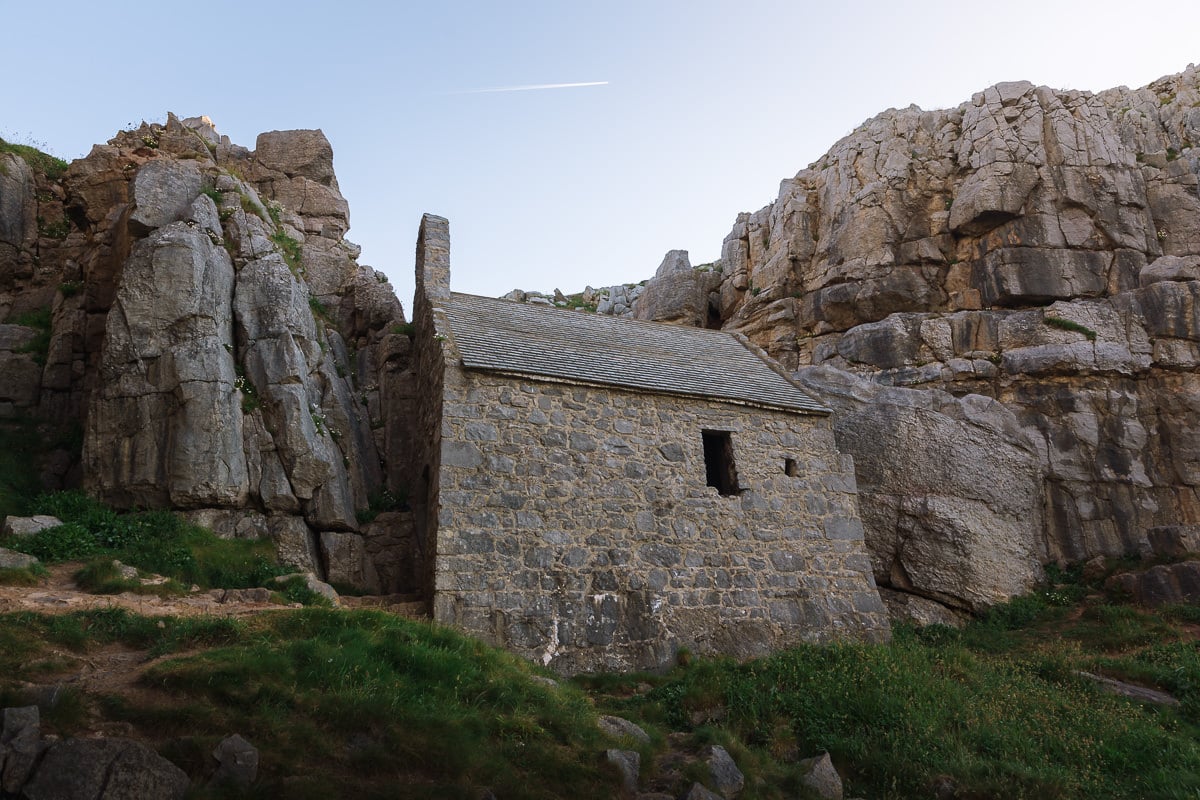 a small chapel wedged between high cliffs