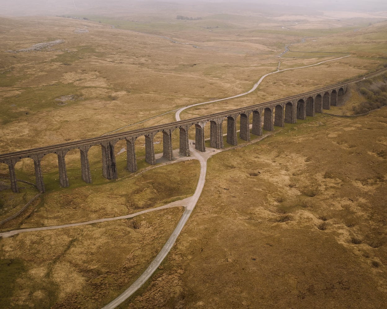Large viaduct with arches curves along a valley