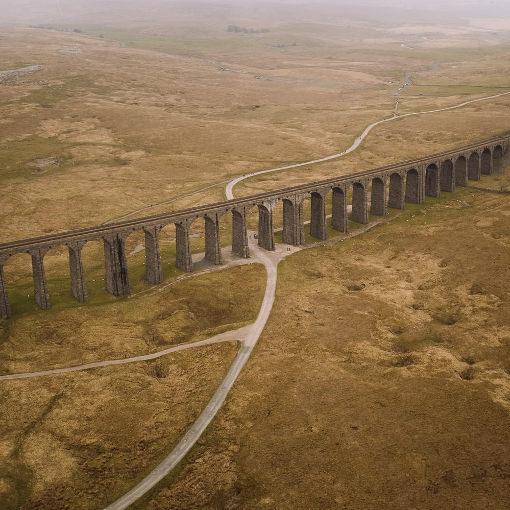 Large viaduct with arches curves along a valley