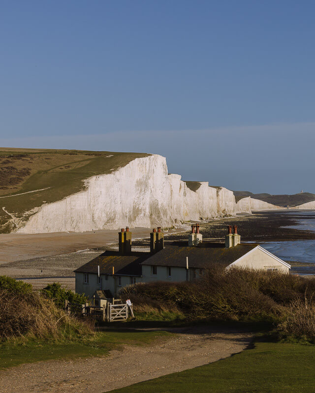 Coast guard cottages in front of the Seven Sisters cliffs at Cuckmere Haven.