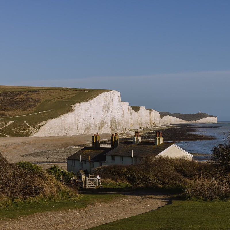 Coast guard cottages in front of the Seven Sisters cliffs at Cuckmere Haven.