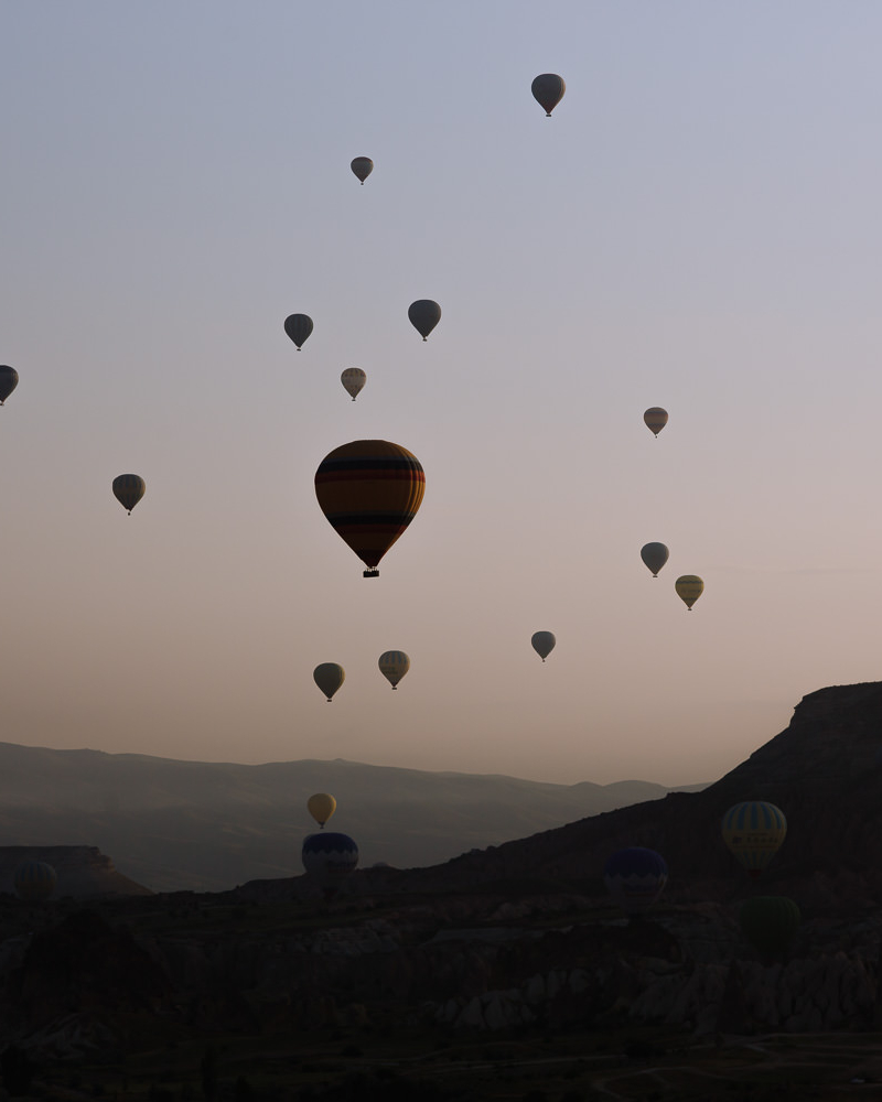 Hot air balloons riding over Cappadocia