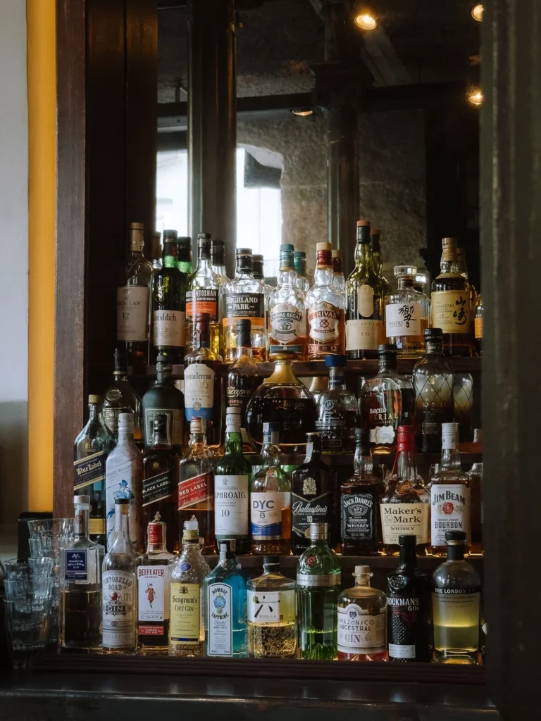 Bottles of whisky, rum and gin displayed behind a Madrid bar.