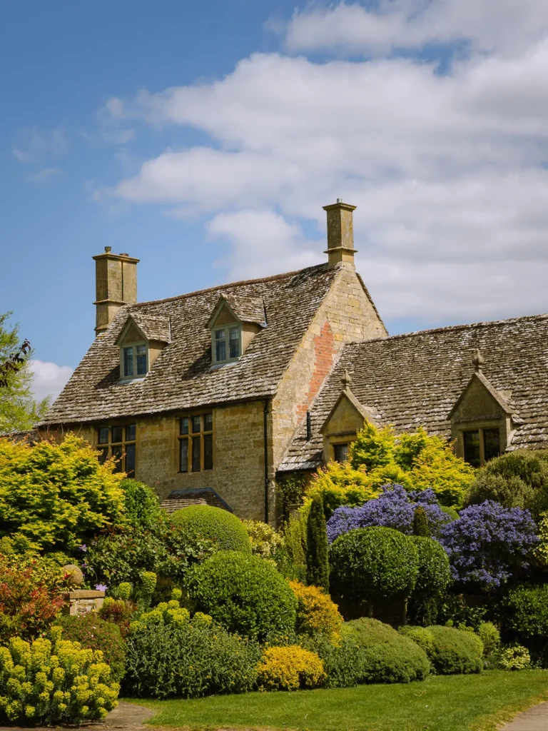 Cotswold stone manor house surrounded by colourful landscaped gardens at Hidcote near Chipping Campden.