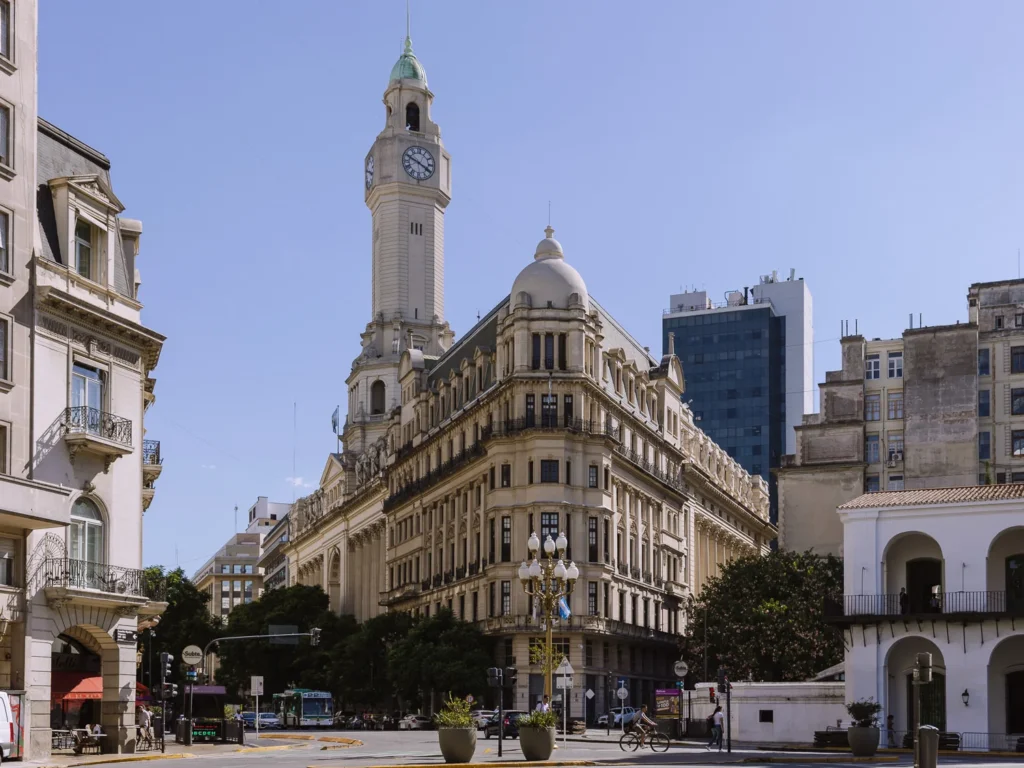 The ornate Beaux-Arts facade of the Buenos Aires City Legislature building on Plaza de Mayo, with its distinctive clock tower rising above the surrounding streets on a clear sunny day
