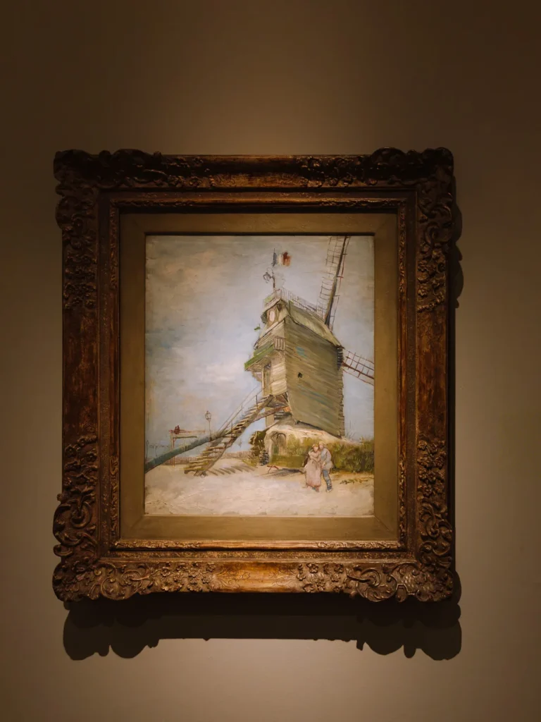 "Le Moulin de la Galette" by Vincent van Gogh on display in an ornate gold frame at the Museo Nacional de Bellas Artes in Buenos Aires