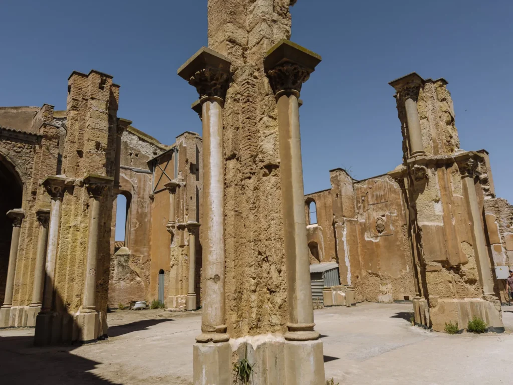 The roofless ruins of the Cathedral of Santa María la Vieja in Cartagena, Spain, with stone columns and crumbling walls open to the sky — destroyed during the Spanish Civil War in 1939 and left abandoned ever since