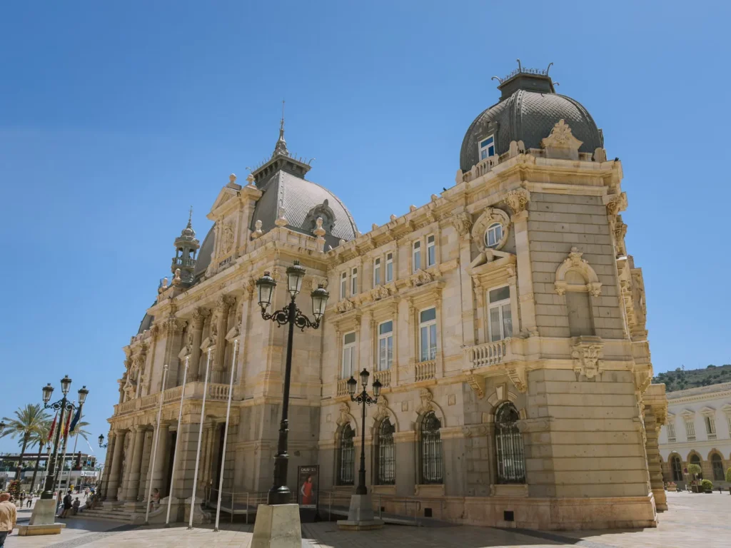The Palacio Consistorial in Cartagena, Spain — a Modernista town hall completed in 1907, featuring white marble facades, zinc domes, and ornate carved detailing