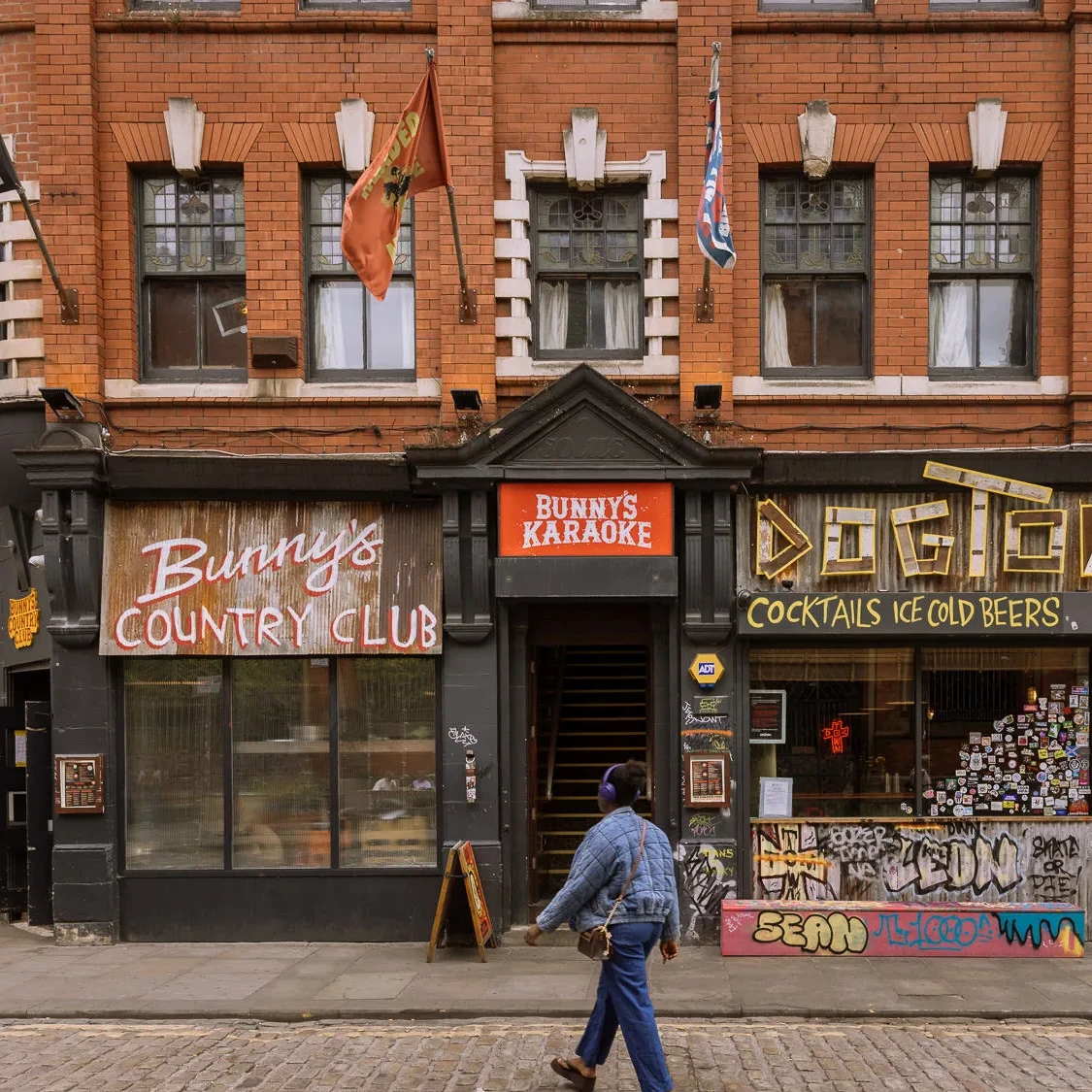 Front of Bunny’s Country Club and Dogtown in Manchester’s Northern Quarter, with colourful signage and a cobbled street in the foreground.