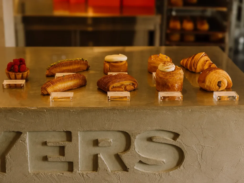 Selection of pastries and cruffins arranged on a café counter in Amsterdam