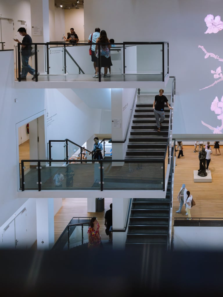 Visitors on the staircases and galleries inside the Van Gogh Museum in Amsterdam